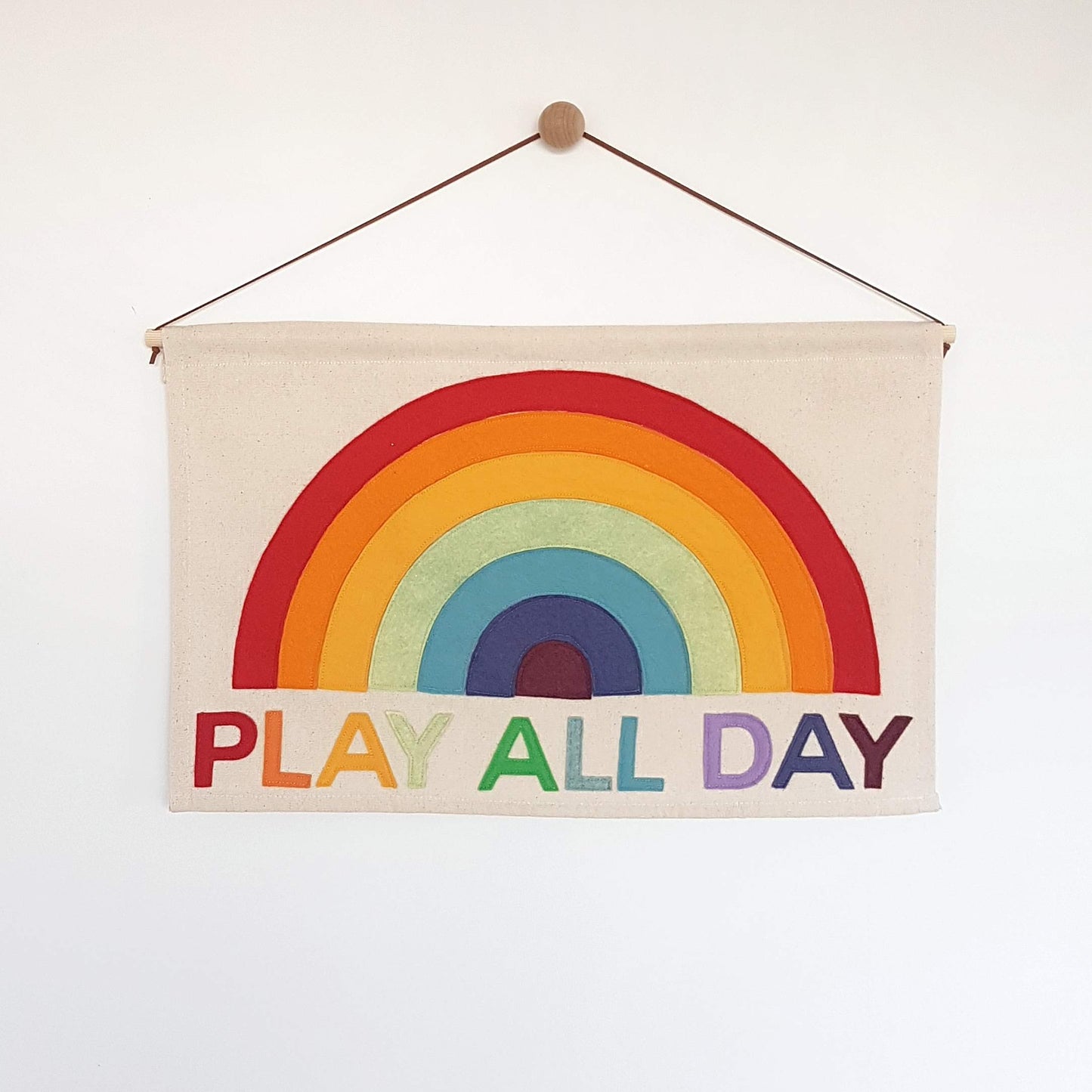 Play All Day wall hanging with rainbow